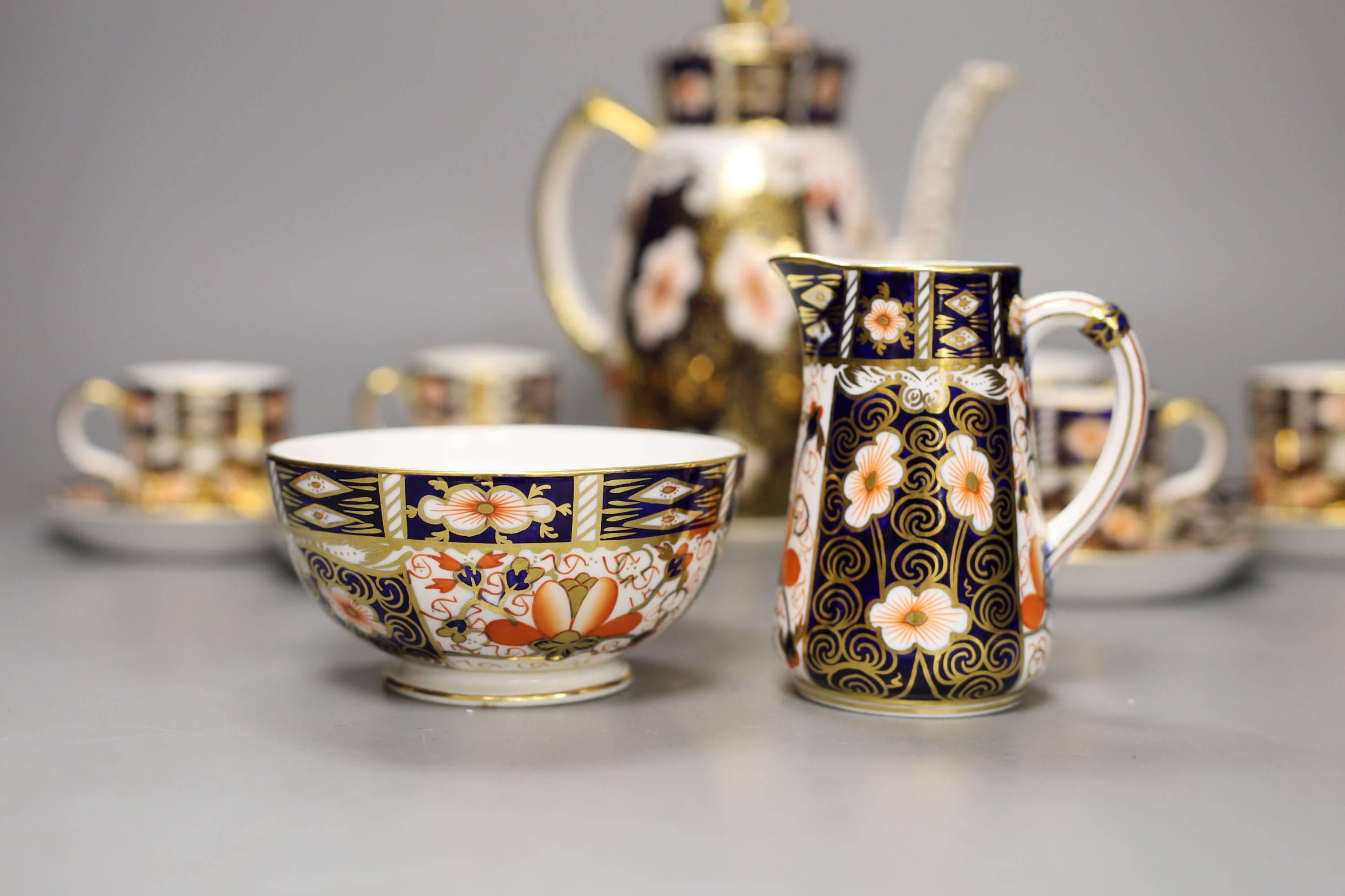 A Royal Crown Derby Imari pattern 2451 coffee set, comprising coffee pot, bowl jug and six cups and saucers.